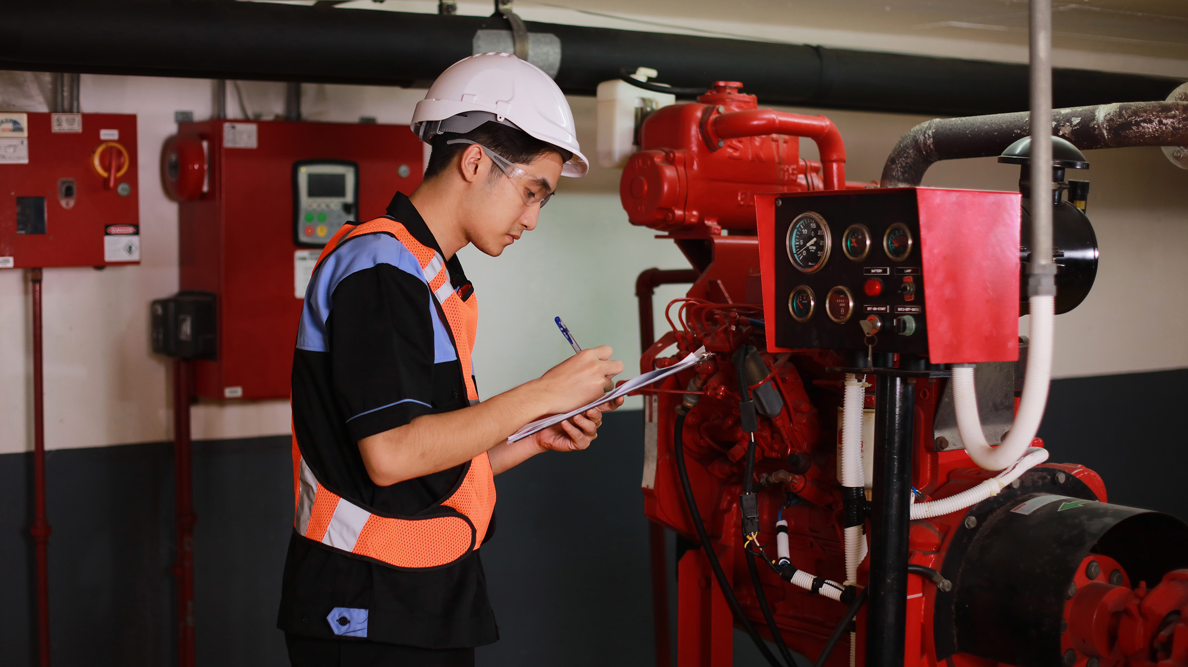 Engineer checking fire suppression system in control room