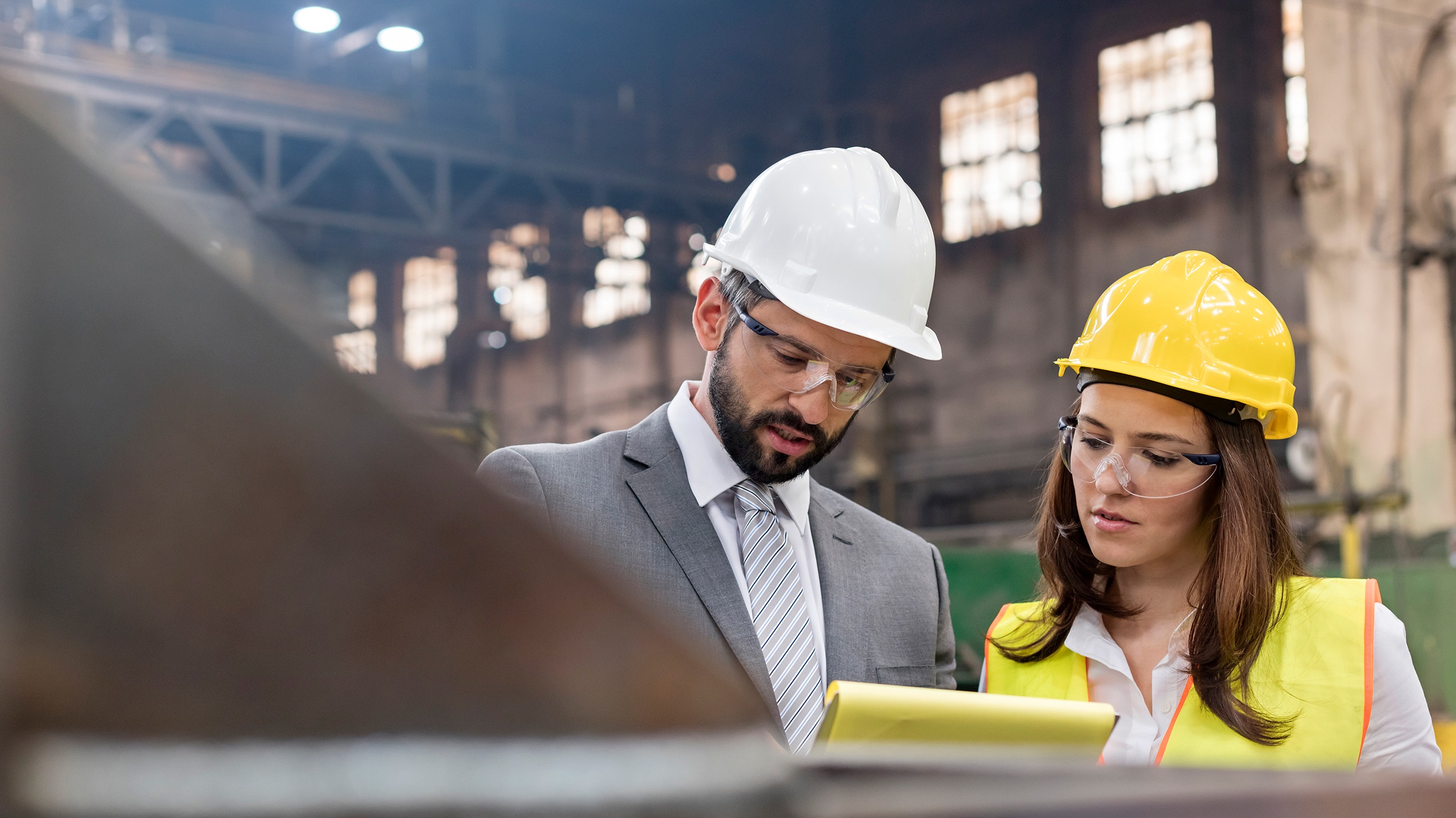 Manager and worker meeting in a factory