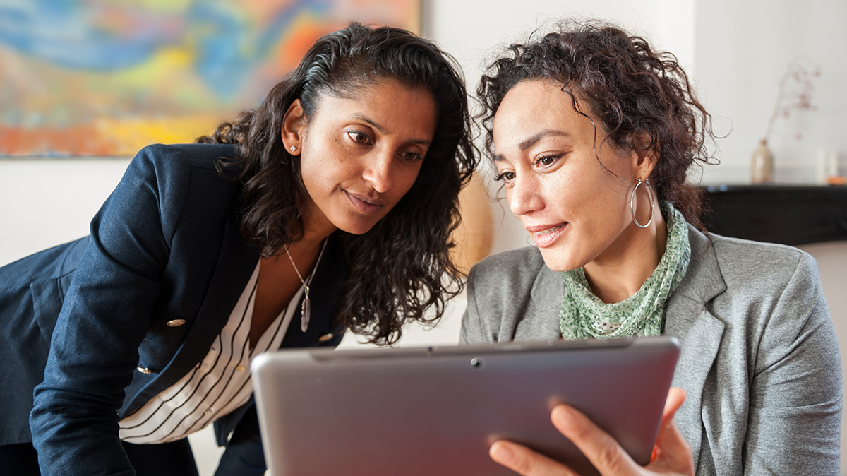 Two people looking at computer screen